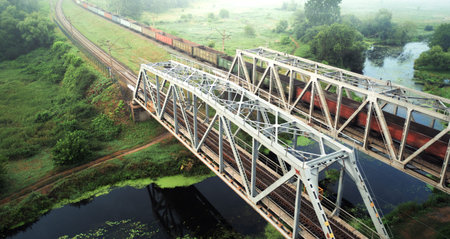 Two railway bridges across the river at dawn.