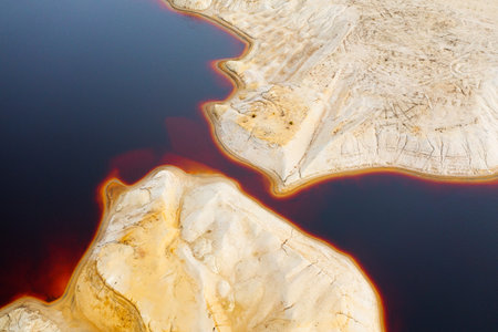 Red toxic water in the tank of the mining and processing plant.