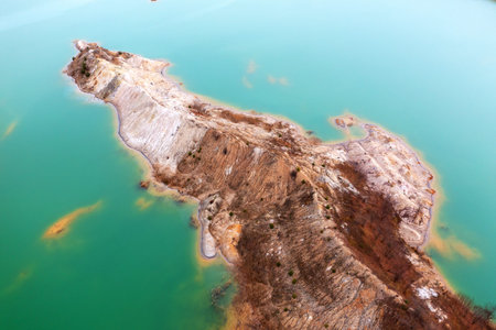 Quarry for mining and enrichment of titanium and other rare ores. Blue water in the enrichment tank.