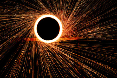 Night fire dance. Sparks from steel wool on a black background. Close-up.の写真素材