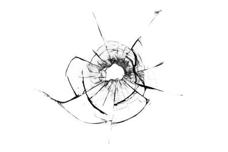 Cracks in the glass from the bullet. abstract background. damaged glass. Cracks on a white background.の写真素材