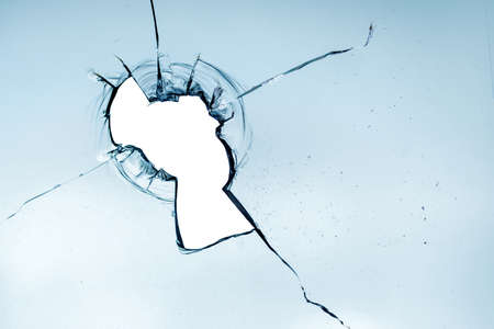 High quality broken glass texture. Hole in dirty glass. On a light background. abstract background.の写真素材