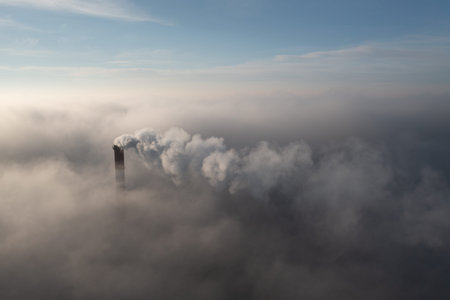 Plant pipe high above the clouds. Harmful emissions into the upper atmosphere. Climate change due to...