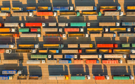 A large number of trucks near the port terminal. traffic jam on the road. The concept of transporting a large number of goods by road.の写真素材