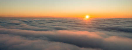 Sunrise high above the clouds. Bright colored morning sky.の写真素材
