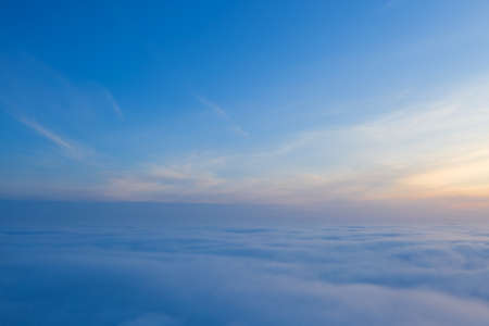 Above the clouds, sunrise or sunset. clear sky over fog. view from the plane. Concept, travel, vacation. relax.の写真素材
