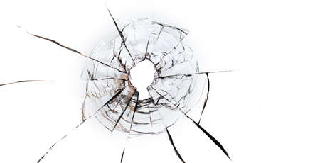 Bullet hole in the glass on a white background. macro.の写真素材