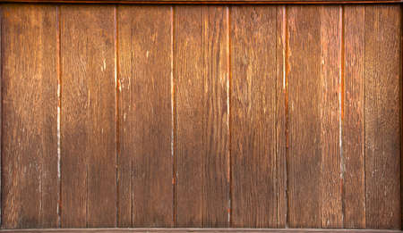 Old yellow wooden wall, aged in the rain and sun. Natural abstract plank background.の写真素材