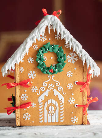 Gingerbread house on a white wooden table selective focus. New Year's gift.の写真素材