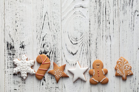 Collection of Christmas gingerbread cookies on a white wooden background Christmas textureの写真素材