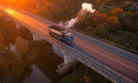 The highway, the bridge over the river on which cars move. Dawn over the autumn forest. Wonderful...