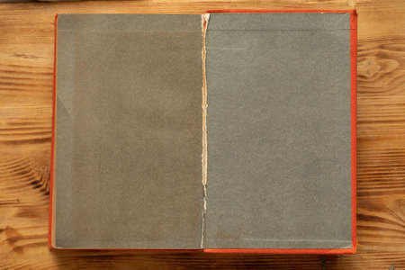 An old unfolded, tattered and yellowed book with blank pages.の写真素材