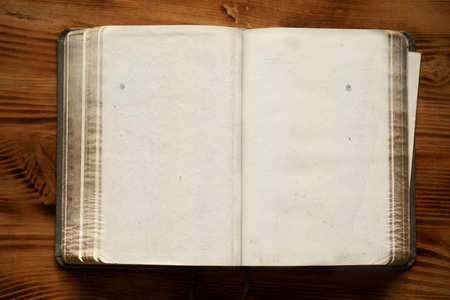An old unfolded, tattered and yellowed book with blank pages.の写真素材
