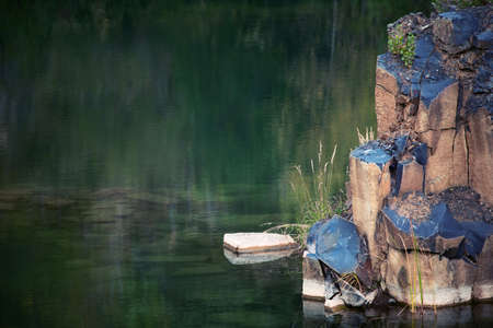 Basalt pillars protrude above the water. landscape.の写真素材