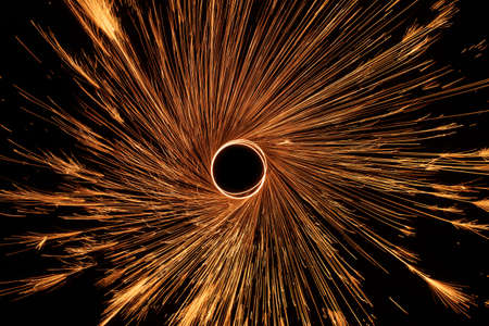 Sparks from steel wool on a background of the night sky. long exposure.の写真素材
