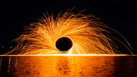 Sparks from steel wool on a background of the night sky. long exposure.の写真素材