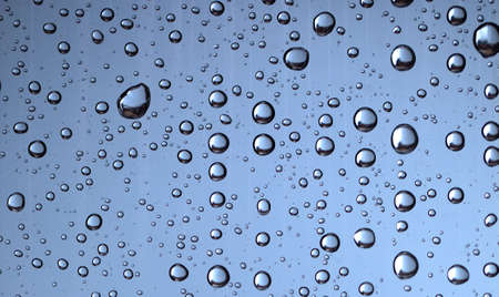 Water drops on glass, abstract background or texture, close-up.の写真素材