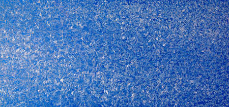 Frost on the glass. Patterns of ice crystals. natural abstract background.の写真素材