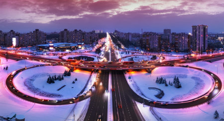 Top view, multilevel transport interchange in the evening city. winter landscape.