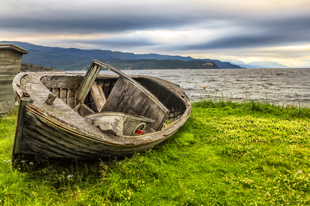 Old fishing boat and beautiful sunset on Jiepmaluokta bay  in Norway.の写真素材
