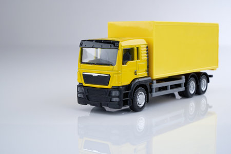 yellow toy truck against yellow backgroundの写真素材
