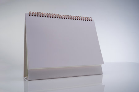 blank desk calendar against white backgroundの写真素材