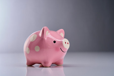 pink piggy bank against  gray backgroundの写真素材