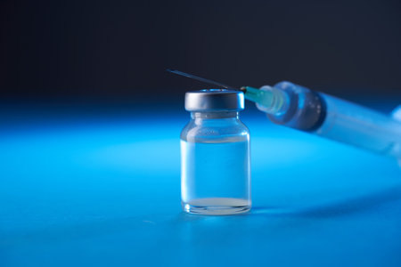 vaccine bottle on the blue backgroundの写真素材