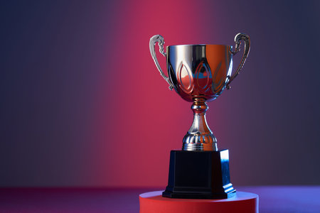 wining gold colored trophy on red purple backgroundの写真素材