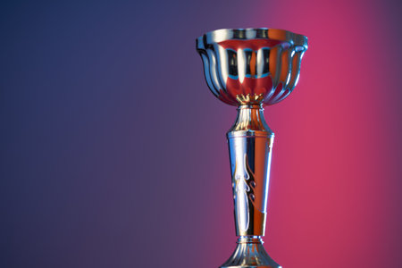 wining gold colored trophy on red purple backgroundの写真素材