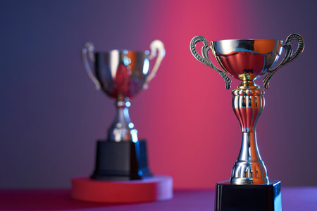 wining gold colored trophy on red purple backgroundの写真素材