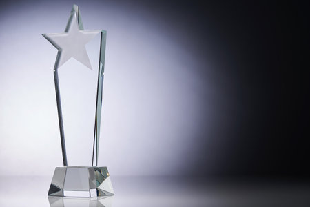 star shape of crystal glass trophy against gray backgroundの写真素材