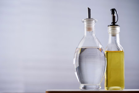white vinegar and olive oil on wood table topの写真素材