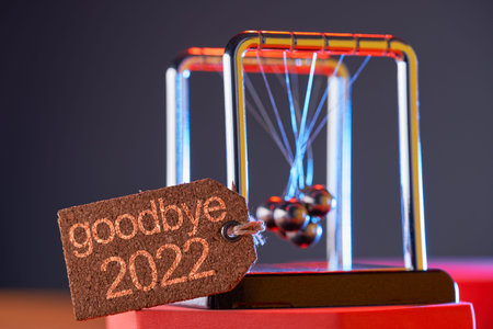 close up newton pendulum tangled together with tag goodbye 2021
