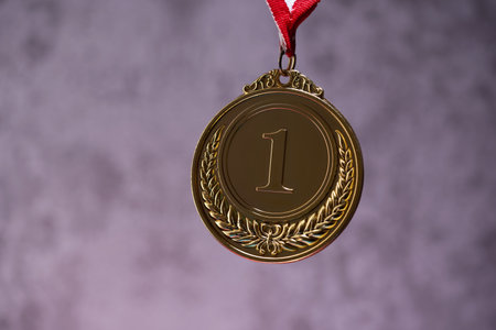glod medal against gray backgroundの写真素材