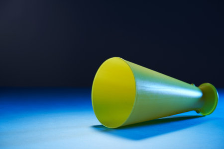 yellow plastic megaphone on blue backgroundの写真素材