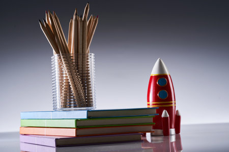 Bright toy rocket and school supplies on gray backgroundの写真素材