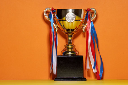 close up of golden trophyon orange backgroundの写真素材