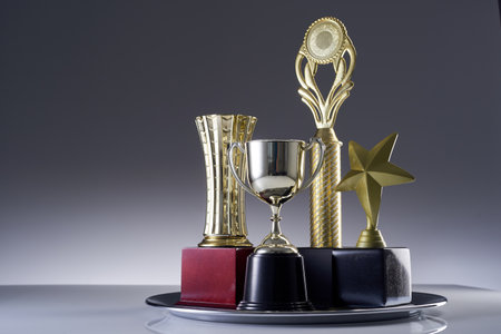 close up  group of golden trophy  on silver trayの写真素材