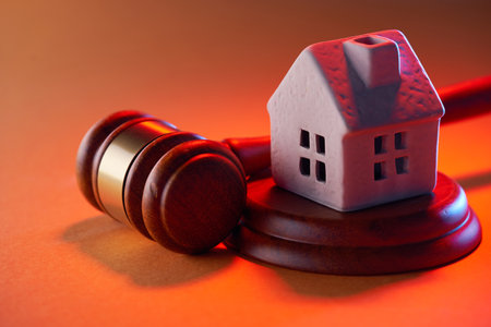 Wooden judge hammer and house modelの写真素材