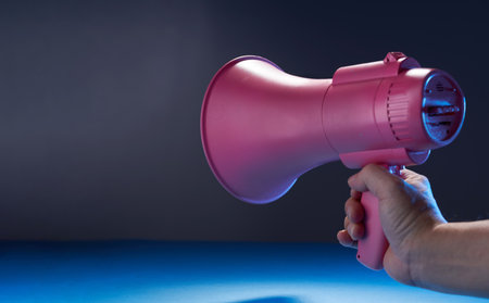 hand holding pink megaphone with copy spaceの写真素材