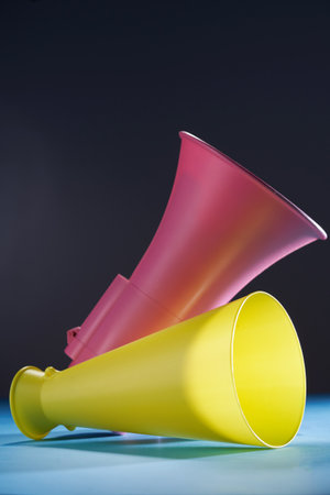 Pink electronic and yellow megaphone on white background.の写真素材