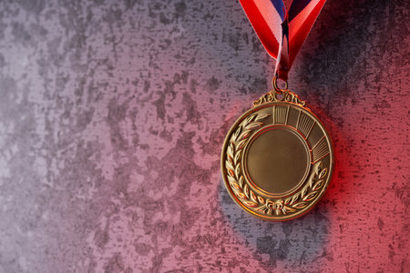 glod medal against gray backgroundの写真素材