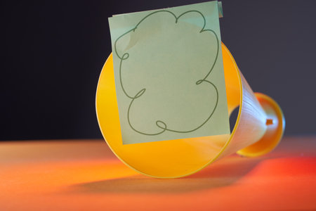 close up of megaphone with note pad on orange backgroundの写真素材