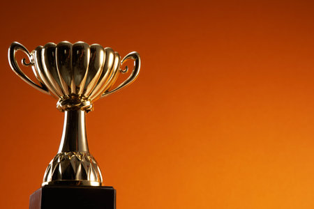 award trophy against orange backgroundの写真素材