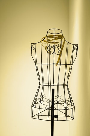 Stylish wire tailor's mannequin isolated on yellowの写真素材