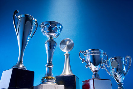 low angle view of winning trophy against blue backgroundの写真素材