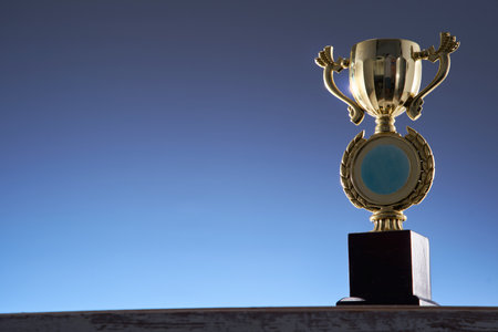 low angle view of winning trophy against blue backgroundの写真素材