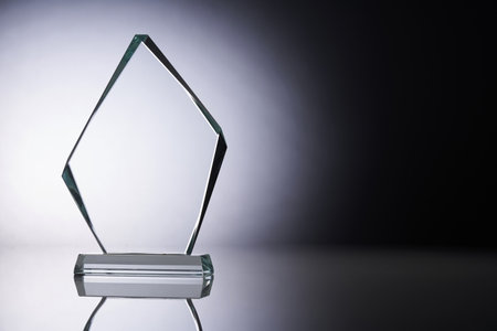 Crystal or glass trophy against gray backgroundの写真素材