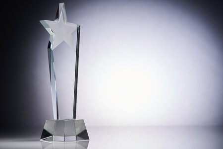star shape of crydtal glass trophy against gray backgroundの写真素材